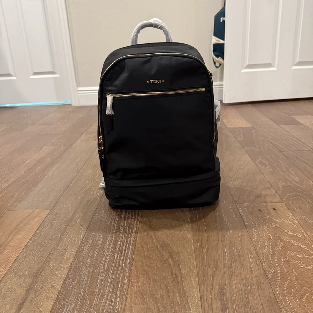 Tumi Backpack in Black with Gold Details and multiple components